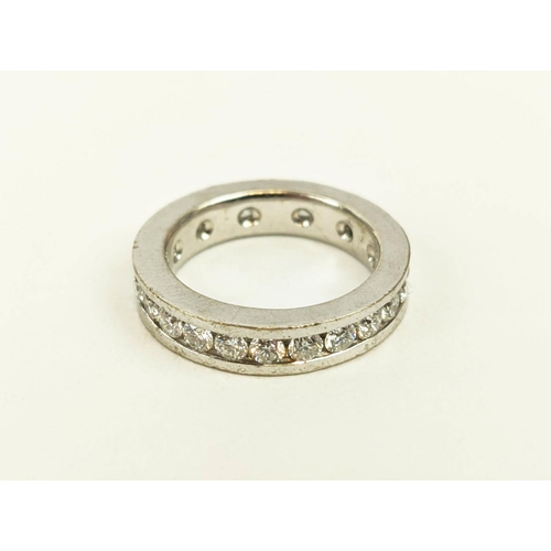 4 - A DIAMOND SET WHITE METAL ETERNITY RING, set with 24 round brilliant cut diamonds, channel set, each... 