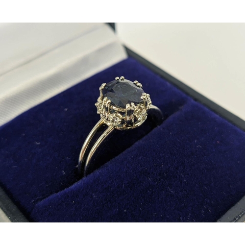 5 - A SAPPHIRE AND DIAMOND SET DRESS RING, the single stone sapphire of approximately 1 carat, claw set ... 