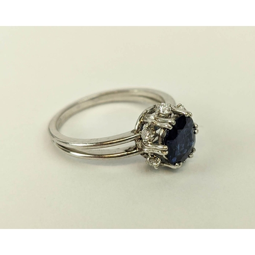 5 - A SAPPHIRE AND DIAMOND SET DRESS RING, the single stone sapphire of approximately 1 carat, claw set ... 