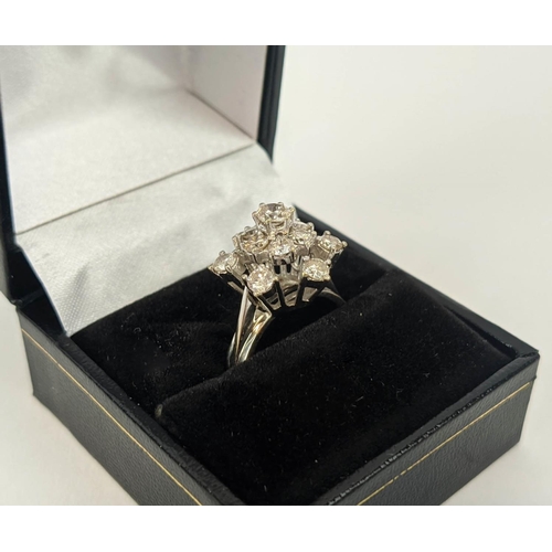 6 - AN 18CT WHITE GOLD DIAMOND FLOWER HEAD COCKTAIL RING, with a central stone of approximately 0.25 car... 