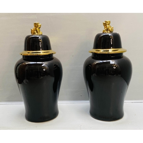 439 - TEMPLE JARS WITH COVERS, 82cm high, 39cm diameter, black glazed ceramic, gilt detail. (2)