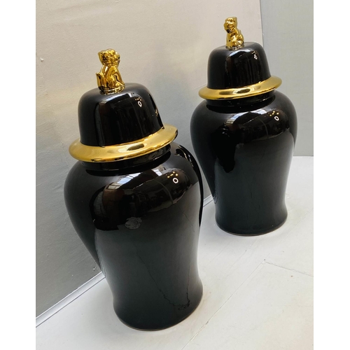 439 - TEMPLE JARS WITH COVERS, 82cm high, 39cm diameter, black glazed ceramic, gilt detail. (2)