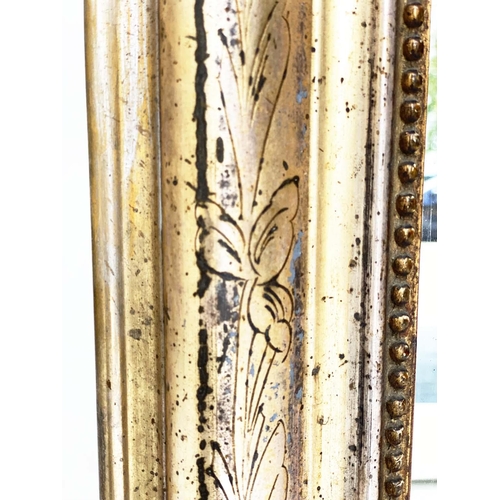 111 - OVERMANTEL MIRROR, 19th century French arched giltwood and composition incised moulded and beaded fr... 