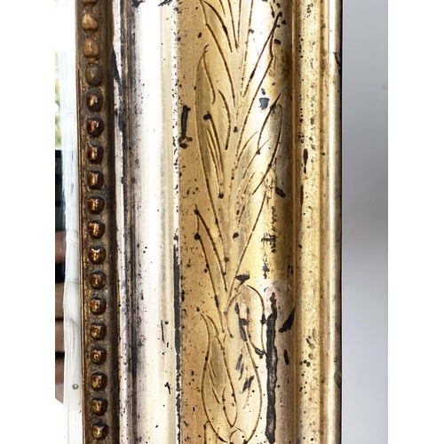 111 - OVERMANTEL MIRROR, 19th century French arched giltwood and composition incised moulded and beaded fr... 