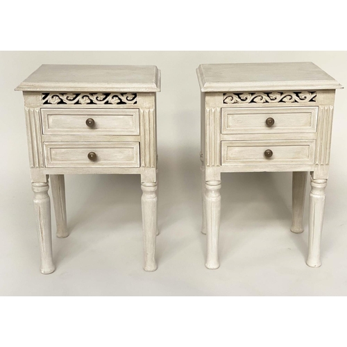 132 - BEDSIDE CHESTS, a pair, French style traditionally grey painted each with two drawer and pierced fri... 