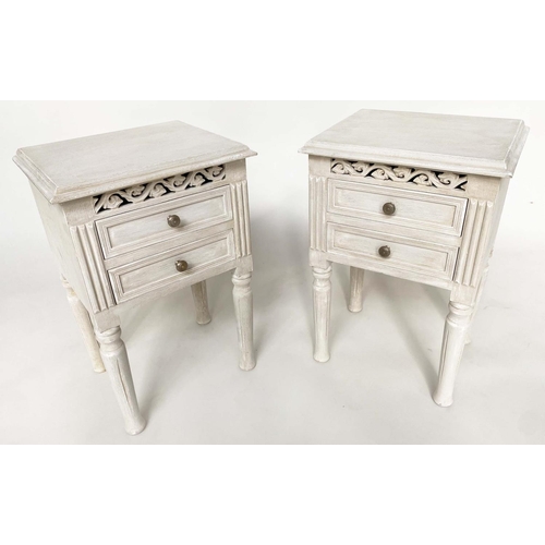 132 - BEDSIDE CHESTS, a pair, French style traditionally grey painted each with two drawer and pierced fri... 