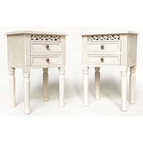 132 - BEDSIDE CHESTS, a pair, French style traditionally grey painted each with two drawer and pierced fri... 