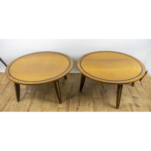 284 - LOW TABLES, 42cm H x 90cm D, a pair, oak with circular ebonised banded tops on brass capped legs. (2... 