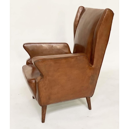 287 - WING ARMCHAIRS, a pair, 1950s Italian mid brown leather, with slightly splayed leather clad supports... 