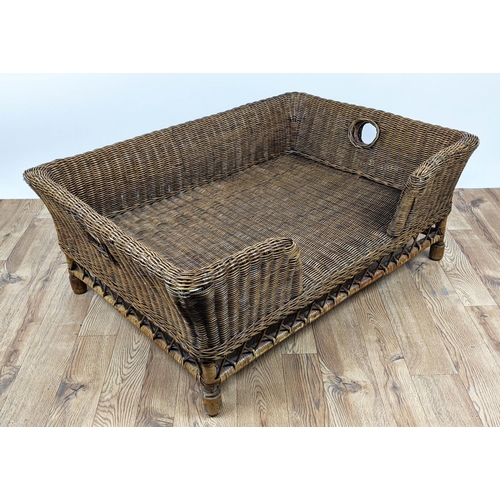 495 - OKA RATTAN MATTABAN PET BED, 77cm D x 44cm H x 108cm W.