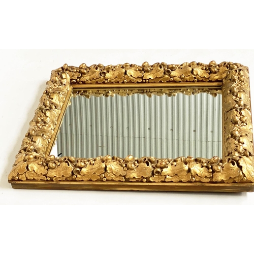 115 - WALL MIRROR, 19th century giltwood and composition, with carved oak leaf frame, 76cm x 63cm.