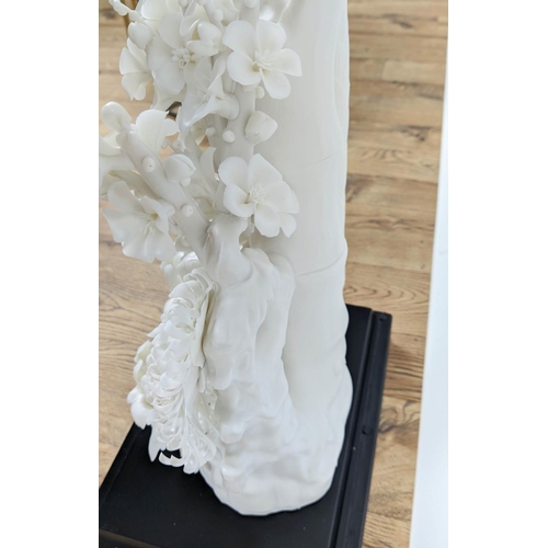 18 - BLANC DE CHINE PORCELAIN FLOWER DISPLAY, with an ebonised and glass case, 54cm H x 34cm x 24cm.