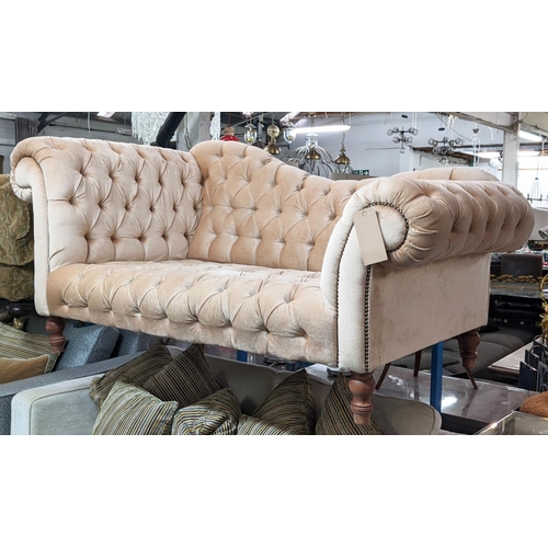 511 - SOFA, 178cm L x 83cm H with buttoned upholstery on short turned supports.