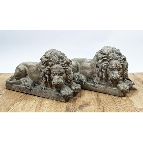 519 - SCULPTURAL RECUMBENT LIONS, a pair, 52cm x 22cm x 30cm, resin, faux stone finish. (2)