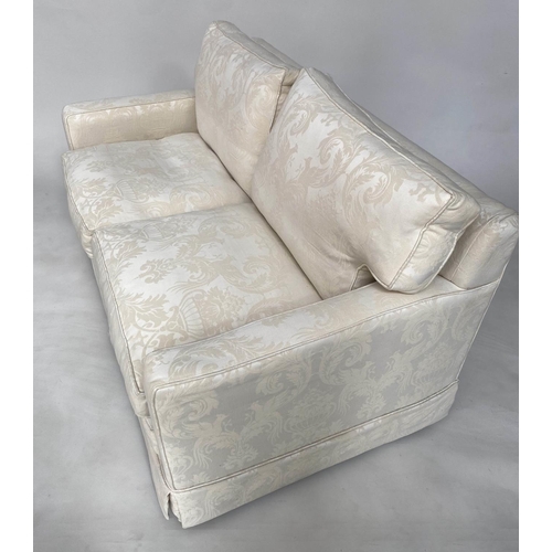 145 - SOFA, traditional two seater ivory brocade upholstered with down feather filled cushions, 135cm W.