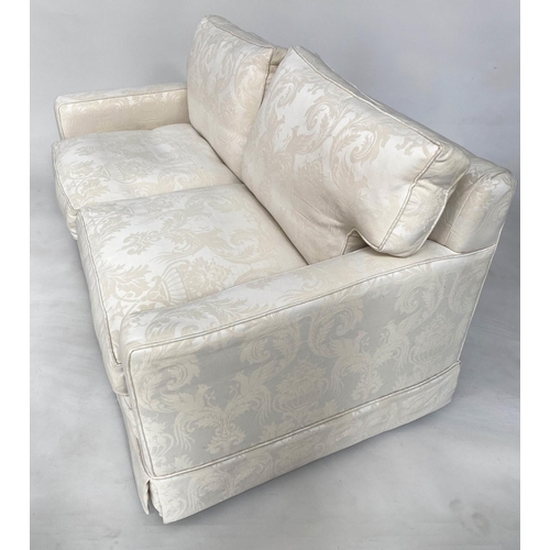 145 - SOFA, traditional two seater ivory brocade upholstered with down feather filled cushions, 135cm W.