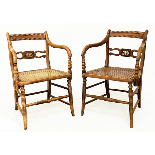 147 - ARMCHAIRS, a pair, Regency style brass inlaid, with cane seats and ring turned supports. (2)