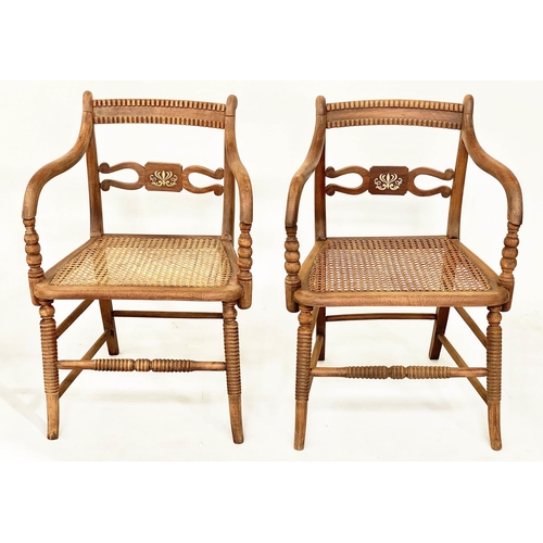 147 - ARMCHAIRS, a pair, Regency style brass inlaid, with cane seats and ring turned supports. (2)