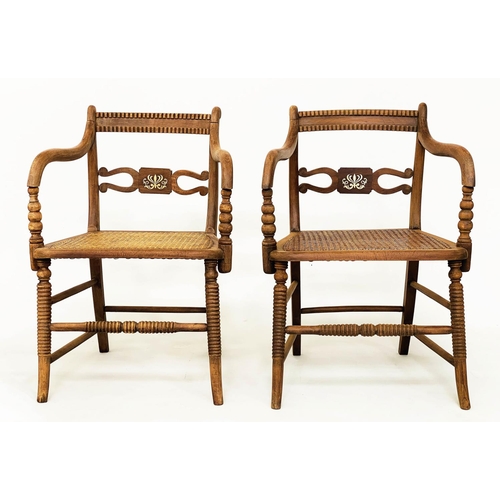 147 - ARMCHAIRS, a pair, Regency style brass inlaid, with cane seats and ring turned supports. (2)