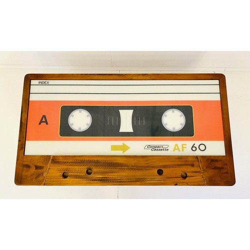 438 - LOW TABLE, 40cm high x 110cm wide x 60cm deep, cassette tape design, with storage to one side.