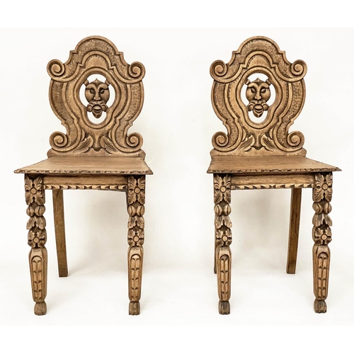 118 - HALL CHAIRS, a pair, 19th century Gothic oak each with carved and pierced lion mask backs, 43cm W. (... 