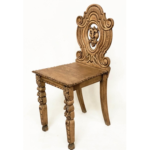 118 - HALL CHAIRS, a pair, 19th century Gothic oak each with carved and pierced lion mask backs, 43cm W. (... 