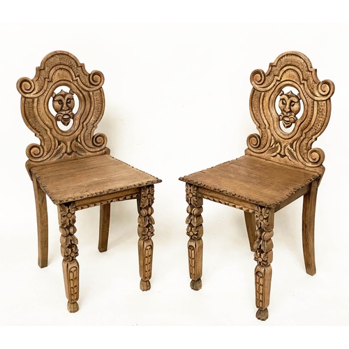 118 - HALL CHAIRS, a pair, 19th century Gothic oak each with carved and pierced lion mask backs, 43cm W. (... 