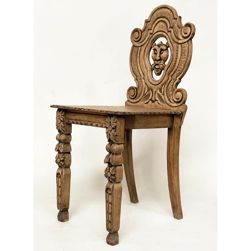 118 - HALL CHAIRS, a pair, 19th century Gothic oak each with carved and pierced lion mask backs, 43cm W. (... 