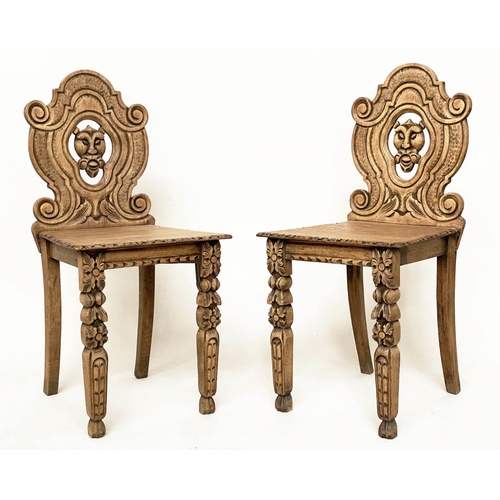 118 - HALL CHAIRS, a pair, 19th century Gothic oak each with carved and pierced lion mask backs, 43cm W. (... 