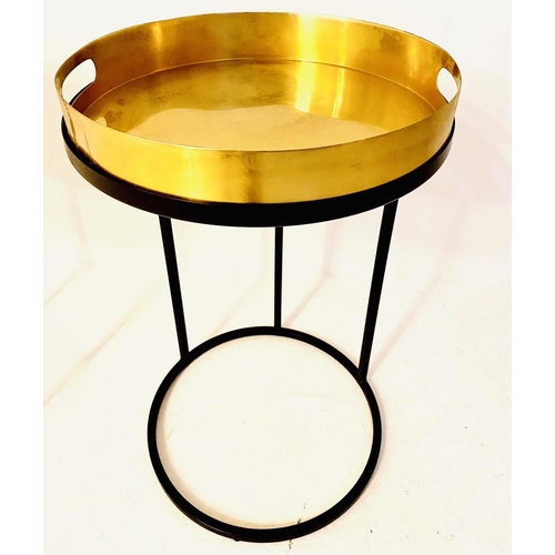 323 - TRAY TABLES, 57cm high, 36cm in diameter, a pair, the gilt metal trays raised on black painted metal... 