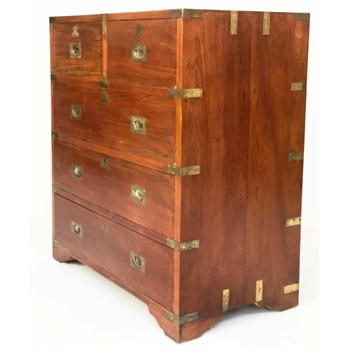 109 - CAMPAIGN STYLE CHEST, mid 20th century Indian, teak and brass bound with two short and three long dr... 