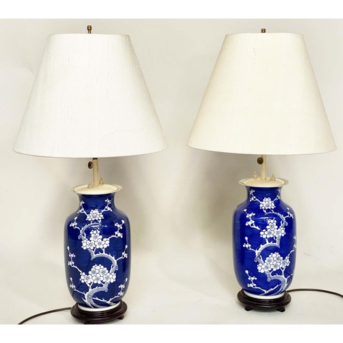 117 - TABLE LAMPS, a pair, Chinese white on deep blue ceramic, vase form, adjustable height with wooden ba... 