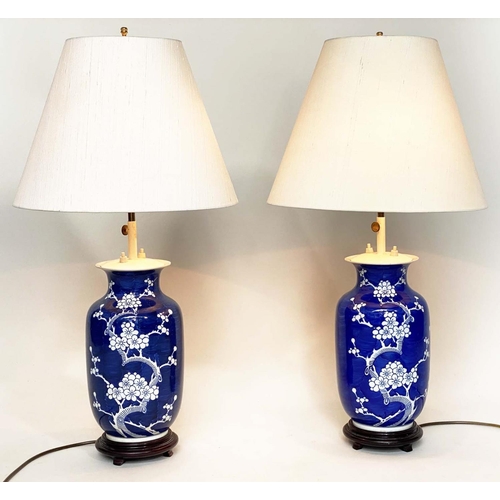 117 - TABLE LAMPS, a pair, Chinese white on deep blue ceramic, vase form, adjustable height with wooden ba... 