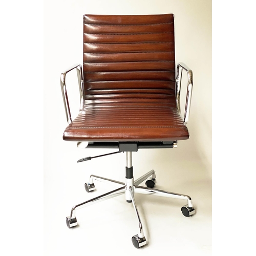 121 - REVOLVING DESK CHAIR, Charles and Ray Eames inspired with ribbed tan leather seat revolving and recl... 