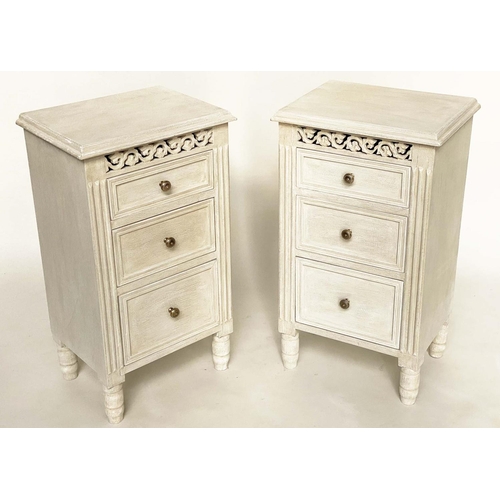 124 - BEDSIDE CHESTS, a pair, French style grey painted each with three drawers and pierced frieze, 40cm x... 