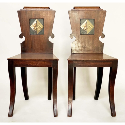 128 - HALL CHAIRS, a pair, Regency mahogany each heraldic panelled back and sabre front supports, 39cm W. ... 