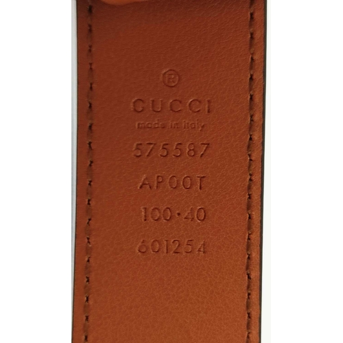 24 - GUCCI UNISEX FRAMED GG LOGO MARMONT BELT, framed GG logo on brass buckle with brown leather, size 10... 