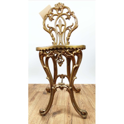 437 - CHAIR AND SIDE TABLE, Regency style, gilt painted pierced metal with contrasting colour detail to ta... 