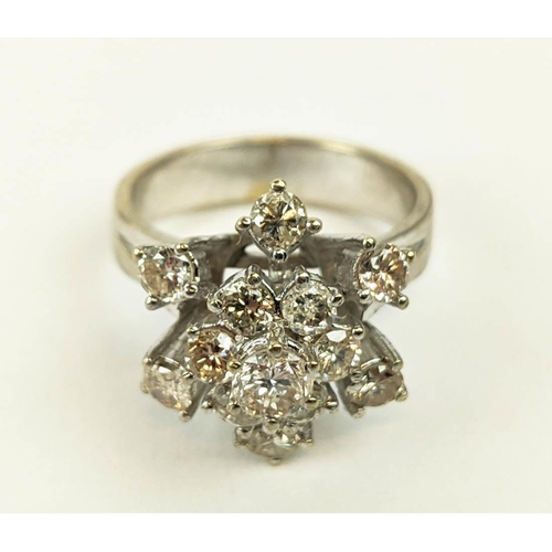 23 - AN 18CT WHITE GOLD DIAMOND FLOWER HEAD COCKTAIL RING, with a central stone of approximately 0.25 car... 