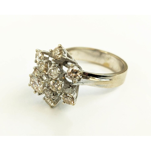 23 - AN 18CT WHITE GOLD DIAMOND FLOWER HEAD COCKTAIL RING, with a central stone of approximately 0.25 car... 