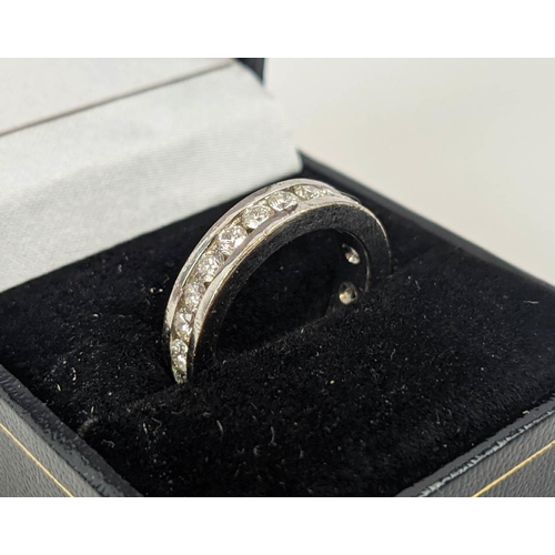 24 - A DIAMOND SET WHITE METAL ETERNITY RING, set with 24 round brilliant cut diamonds, channel set, each... 