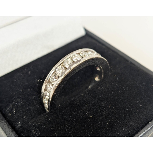 24 - A DIAMOND SET WHITE METAL ETERNITY RING, set with 24 round brilliant cut diamonds, channel set, each... 