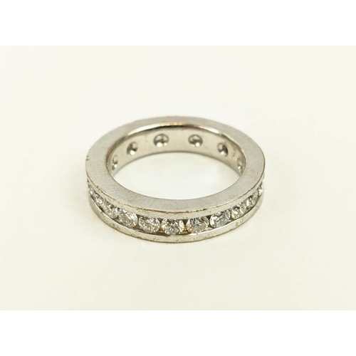 24 - A DIAMOND SET WHITE METAL ETERNITY RING, set with 24 round brilliant cut diamonds, channel set, each... 