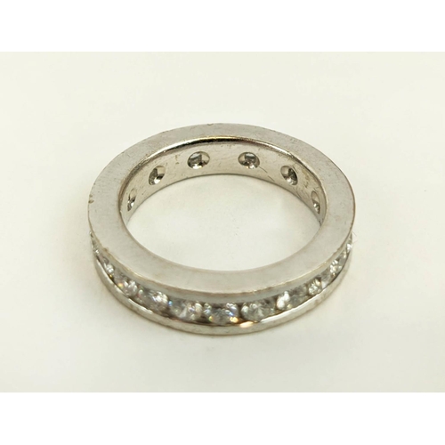 24 - A DIAMOND SET WHITE METAL ETERNITY RING, set with 24 round brilliant cut diamonds, channel set, each... 