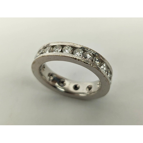 24 - A DIAMOND SET WHITE METAL ETERNITY RING, set with 24 round brilliant cut diamonds, channel set, each... 