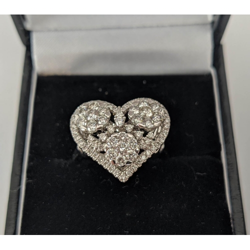 25 - AN 18CT WHITE GOLD DIAMOND DRESS RING, the head in the form of a heart, encrusted with round brillia... 