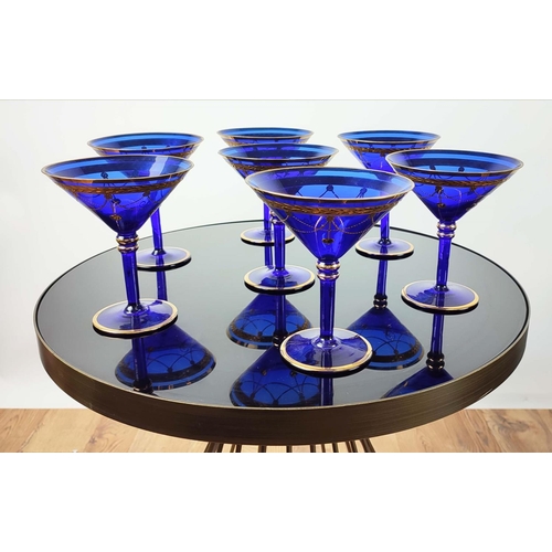 30 - A SET OF VENETIAN COBALT BLUE AND GOLD HAND PAINTED GLASSES, seven champagne coupes, nine martini gl... 