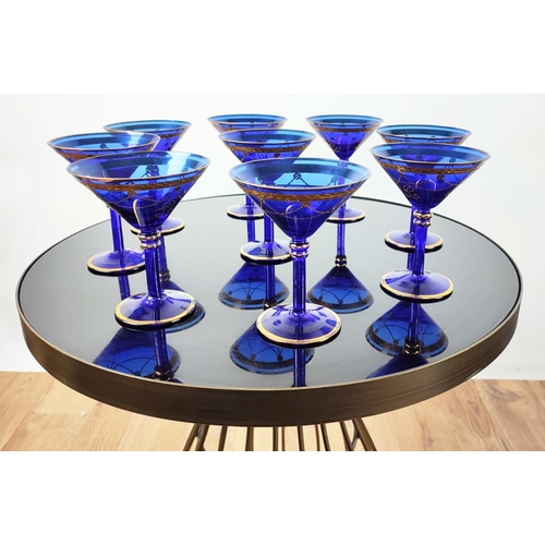 30 - A SET OF VENETIAN COBALT BLUE AND GOLD HAND PAINTED GLASSES, seven champagne coupes, nine martini gl... 