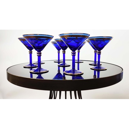 30 - A SET OF VENETIAN COBALT BLUE AND GOLD HAND PAINTED GLASSES, seven champagne coupes, nine martini gl... 