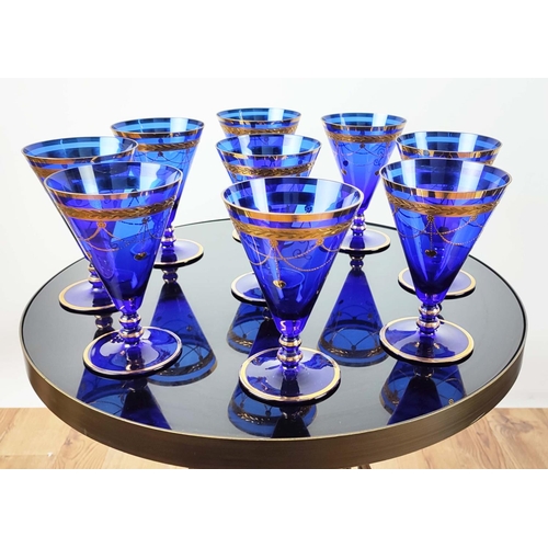 30 - A SET OF VENETIAN COBALT BLUE AND GOLD HAND PAINTED GLASSES, seven champagne coupes, nine martini gl... 